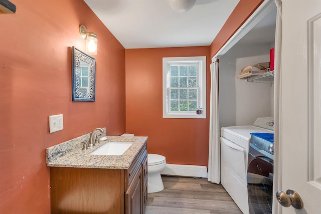 4 June Bug Ln, Wolfeboro, NH 03894 - bathroom with washer / dryer, baseboard heating, vanity, and wood finished floors