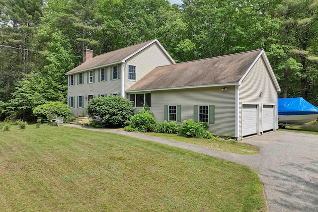 4 June Bug Ln, Wolfeboro, NH 03894 - colonial-style house with driveway, a shingled roof, a front yard, a garage, and a chimney