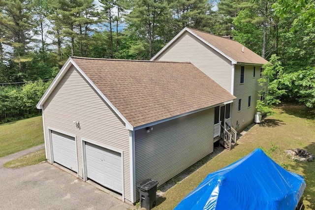 4 June Bug Ln, Wolfeboro, NH 03894 - view of home's exterior featuring roof with shingles, view of wooded area, and a garage