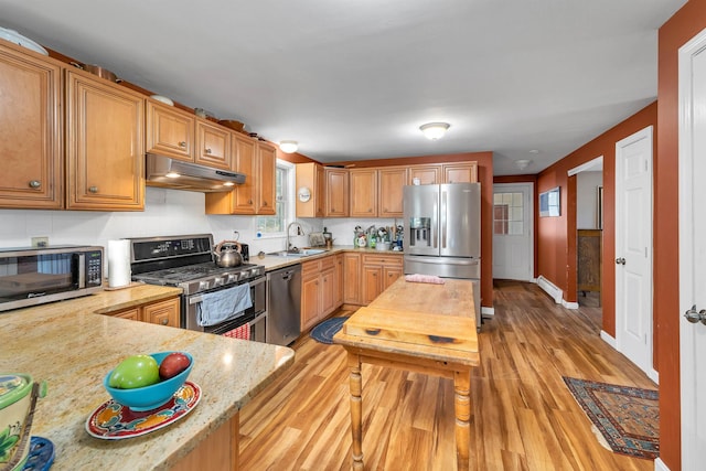 4 June Bug Ln, Wolfeboro, NH 03894 - kitchen featuring stainless steel appliances, under cabinet range hood, light wood-style flooring, light stone counters, and a baseboard heating unit