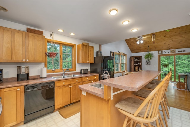 481 New Orchard Rd, Epsom, NH 03234 - kitchen featuring black appliances, light floors, a kitchen bar, lofted ceiling, and an island with sink