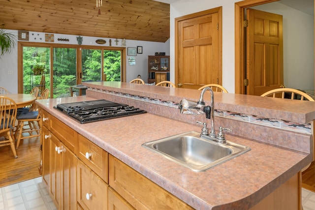 481 New Orchard Rd, Epsom, NH 03234 - kitchen with black stovetop, light floors, light countertops, wood ceiling, and a kitchen island with sink