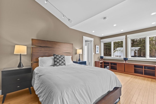 214 Upper Hollow Rd, Stowe, VT 05672 - bedroom featuring wood finished floors, lofted ceiling, recessed lighting, and rail lighting