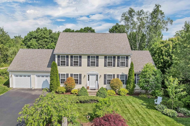 148 Deer Meadow Rd, Pittsfield, NH 03263 - colonial inspired home with asphalt driveway, a garage, a front yard, and roof with shingles