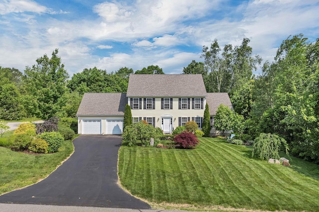 148 Deer Meadow Rd, Pittsfield, NH 03263 - colonial-style house with driveway, a front lawn, roof with shingles, and an attached garage