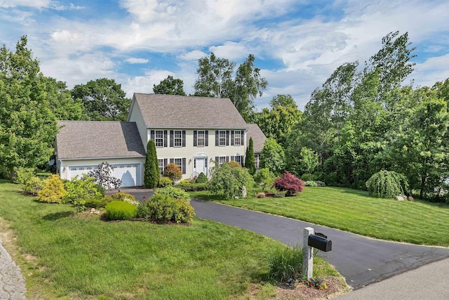 148 Deer Meadow Rd, Pittsfield, NH 03263 - colonial inspired home featuring a front lawn, asphalt driveway, and an attached garage