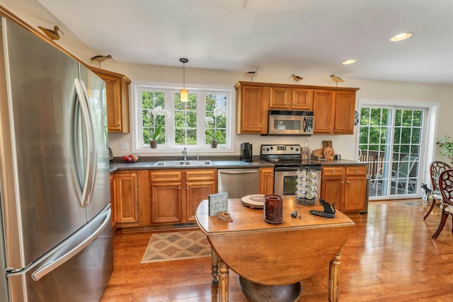 148 Deer Meadow Rd, Pittsfield, NH 03263 - kitchen featuring stainless steel appliances, brown cabinets, dark countertops, and recessed lighting