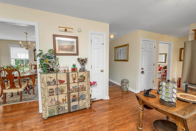 148 Deer Meadow Rd, Pittsfield, NH 03263 - hallway featuring a chandelier and wood finished floors