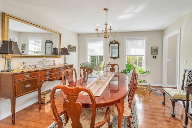 148 Deer Meadow Rd, Pittsfield, NH 03263 - dining room featuring healthy amount of natural light, a chandelier, and light wood finished floors