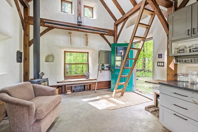 417 Maple Hill Rd, Arlington, VT 05250 - living room with a wood stove, unfinished concrete flooring, plenty of natural light, and high vaulted ceiling