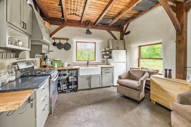 417 Maple Hill Rd, Arlington, VT 05250 - kitchen with gas range, butcher block counters, freestanding refrigerator, open shelves, and finished concrete floors