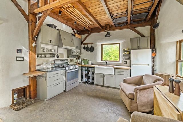 417 Maple Hill Rd, Arlington, VT 05250 - kitchen featuring stainless steel range with gas stovetop, freestanding refrigerator, concrete floors, gray cabinetry, and a wood ceiling with exposed beams