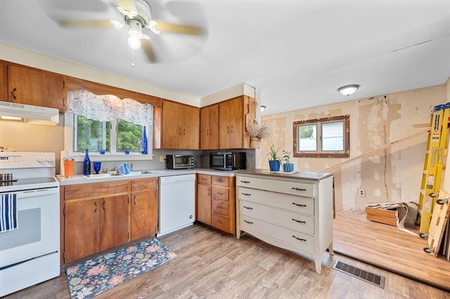 11 Dudley St, Randolph, VT 05660 - kitchen with white appliances, a ceiling fan, light countertops, under cabinet range hood, and healthy amount of natural light
