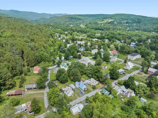 11 Dudley St, Randolph, VT 05660 - aerial overview of property's location with a heavily wooded area and a mountainous background