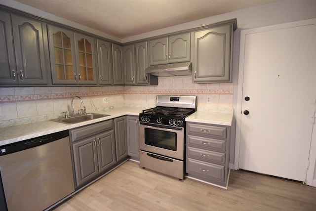 11 Tiffany Rd Unit 5, Salem, NH 03079 - kitchen with stainless steel appliances, under cabinet range hood, gray cabinets, and light wood-type flooring