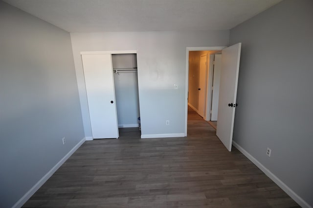 11 Tiffany Rd Unit 5, Salem, NH 03079 - unfurnished bedroom featuring dark wood-style flooring and a closet
