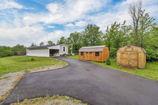 205 Windsor Rd, Hillsborough, NH 03244 - view of front of house featuring a shed, a front lawn, driveway, and a carport