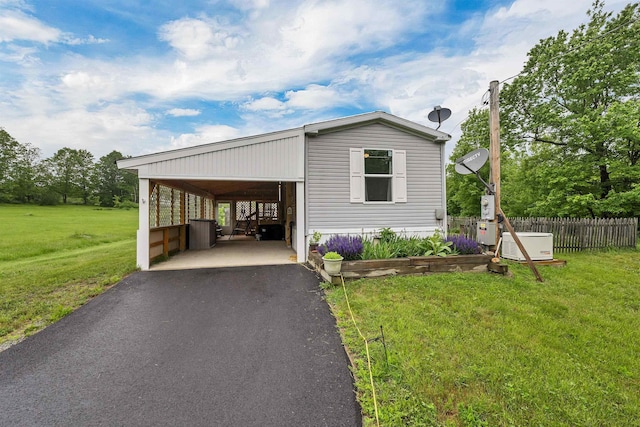 205 Windsor Rd, Hillsborough, NH 03244 - manufactured / mobile home featuring asphalt driveway and a carport