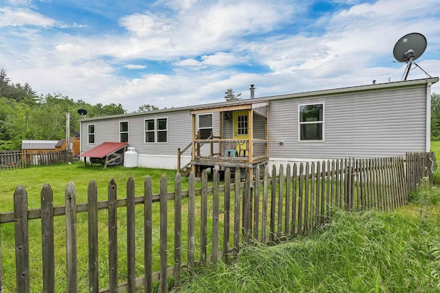 205 Windsor Rd, Hillsborough, NH 03244 - rear view of house with a deck and a fenced backyard