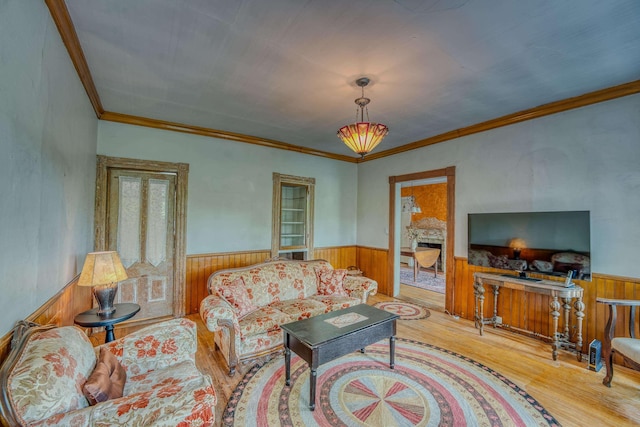 34 Union St, Littleton, NH 03561 - living area featuring wainscoting, wood finished floors, wooden walls, and ornamental molding