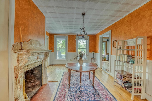 34 Union St, Littleton, NH 03561 - dining area featuring an ornate ceiling, wood finished floors, wainscoting, and a fireplace