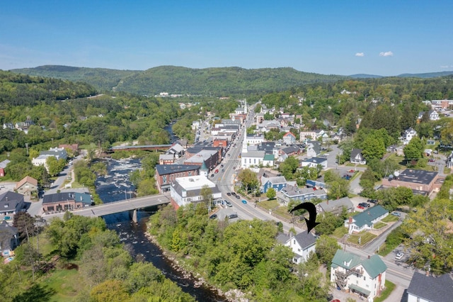34 Union St, Littleton, NH 03561 - aerial view of property's location featuring a heavily wooded area and a mountainous background