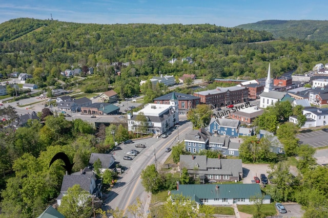 34 Union St, Littleton, NH 03561 - aerial view of property and surrounding area with a heavily wooded area