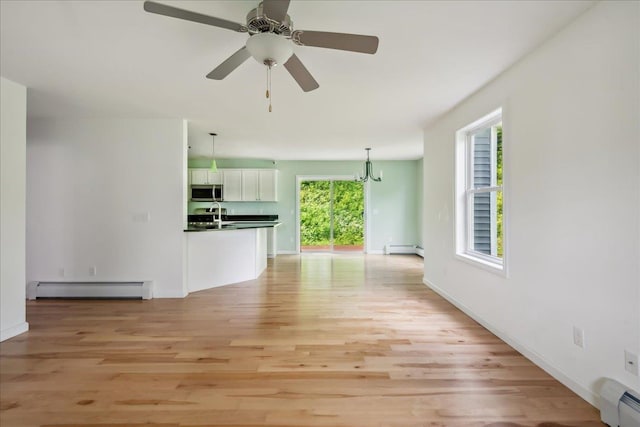 54 Gallagher Acres Ext, Moretown, VT 05676 - unfurnished living room with baseboard heating, light wood finished floors, and a chandelier