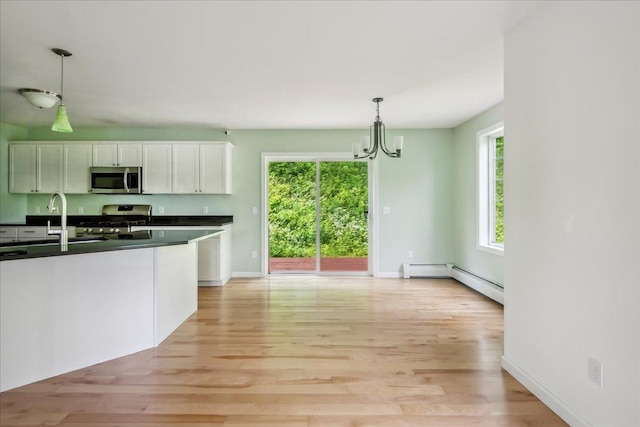 54 Gallagher Acres Ext, Moretown, VT 05676 - kitchen featuring stainless steel appliances, dark countertops, white cabinetry, and light wood finished floors