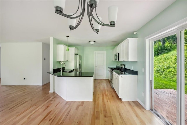 54 Gallagher Acres Ext, Moretown, VT 05676 - kitchen featuring appliances with stainless steel finishes, dark countertops, light wood-style floors, and white cabinetry