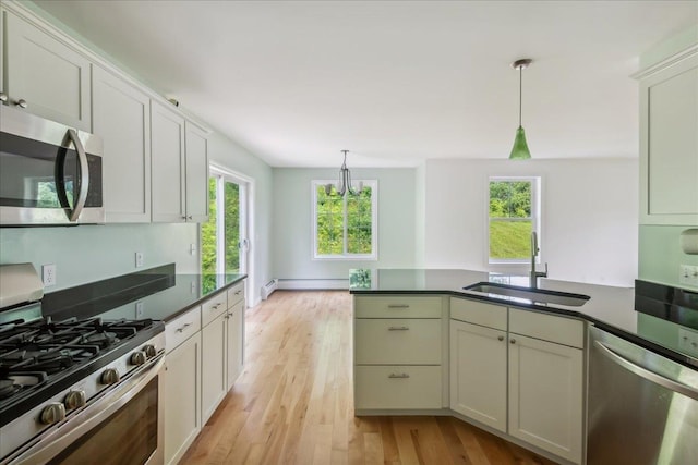 54 Gallagher Acres Ext, Moretown, VT 05676 - kitchen with appliances with stainless steel finishes, a peninsula, dark countertops, and light wood finished floors
