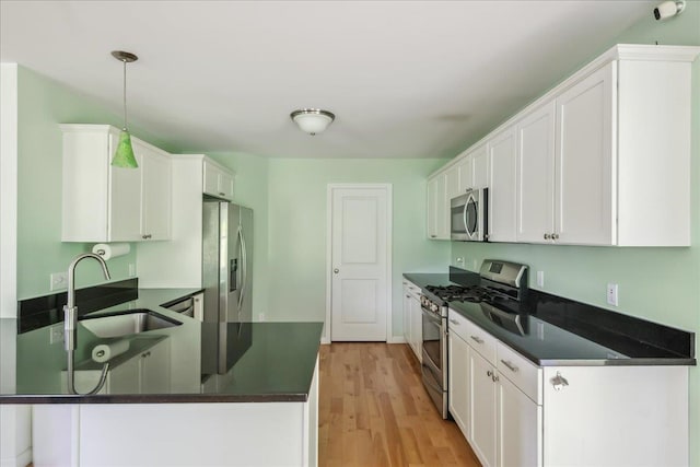 54 Gallagher Acres Ext, Moretown, VT 05676 - kitchen with stainless steel appliances, dark countertops, a peninsula, and white cabinetry