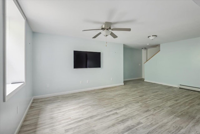 54 Gallagher Acres Ext, Moretown, VT 05676 - unfurnished living room with ceiling fan, light wood-type flooring, and a baseboard radiator