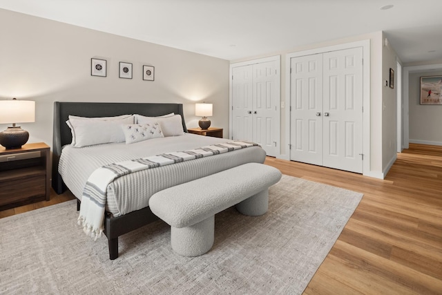 2366 Mountain Rd Unit 1, Stowe, VT 05672 - bedroom featuring two closets and light wood-type flooring