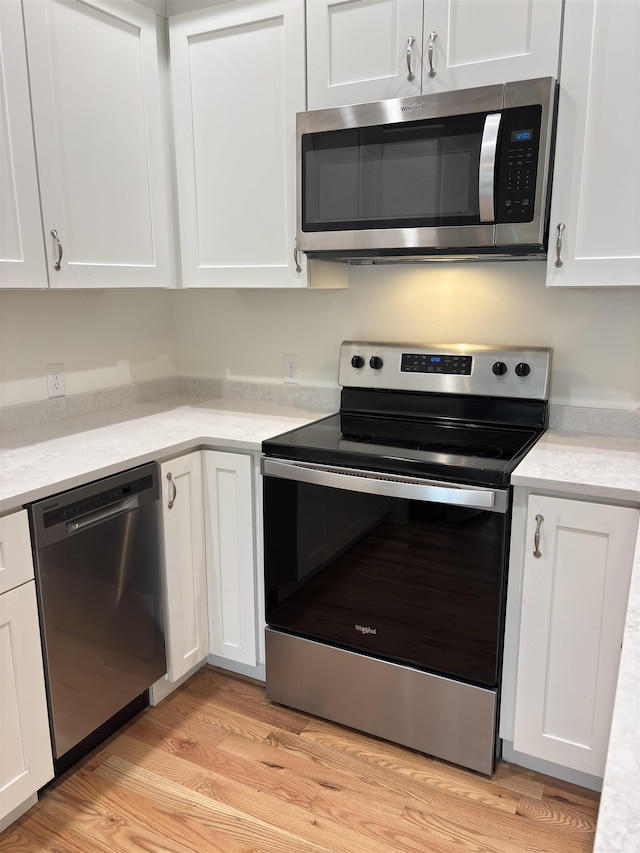 10 Diamond Oaks Blvd Unit 6, Kingston, NH 03848 - kitchen with appliances with stainless steel finishes, white cabinets, and light countertops