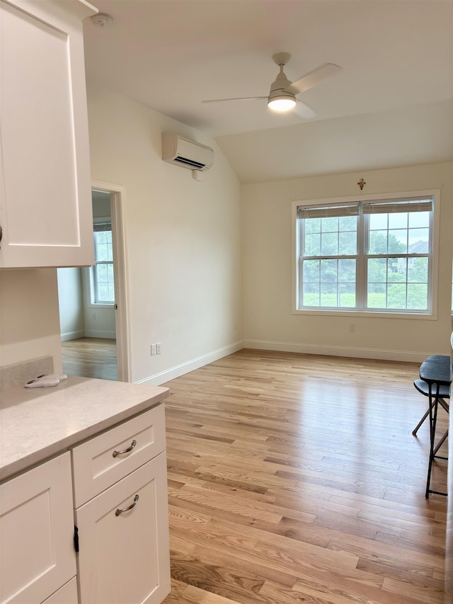 10 Diamond Oaks Blvd Unit 6, Kingston, NH 03848 - unfurnished living room with a wall mounted air conditioner, lofted ceiling, a ceiling fan, and light wood-type flooring