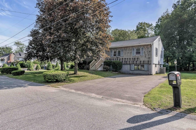 48 Haigh Ave, Salem, NH 03079 - view of front of property with a front lawn, stairway, driveway, and a shingled roof