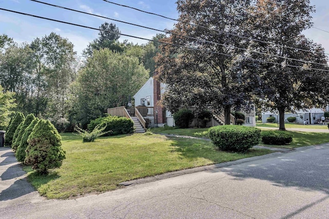 48 Haigh Ave, Salem, NH 03079 - view of front of home featuring stairway, a front yard, and a wooden deck