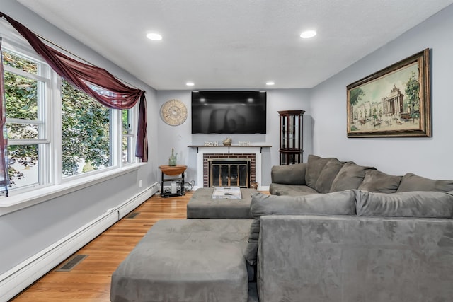 48 Haigh Ave, Salem, NH 03079 - living room with baseboard heating, recessed lighting, a fireplace, and light wood-type flooring