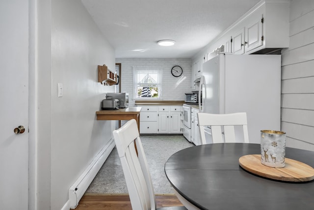 48 Haigh Ave, Salem, NH 03079 - dining space with a baseboard radiator and light wood finished floors