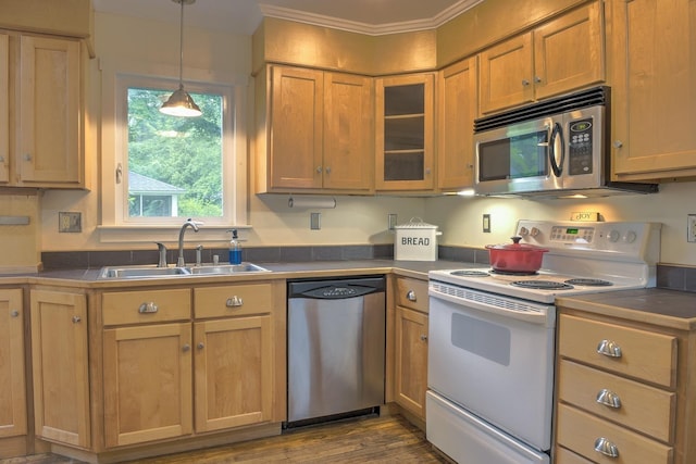 382 Park Ave, Keene, NH 03431 - kitchen featuring appliances with stainless steel finishes, glass insert cabinets, pendant lighting, dark wood finished floors, and ornamental molding