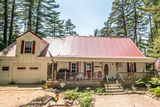 20 Pine Lane Rd, Ossipee, NH 03890 - view of front of home featuring a porch, a metal roof, driveway, and an attached garage