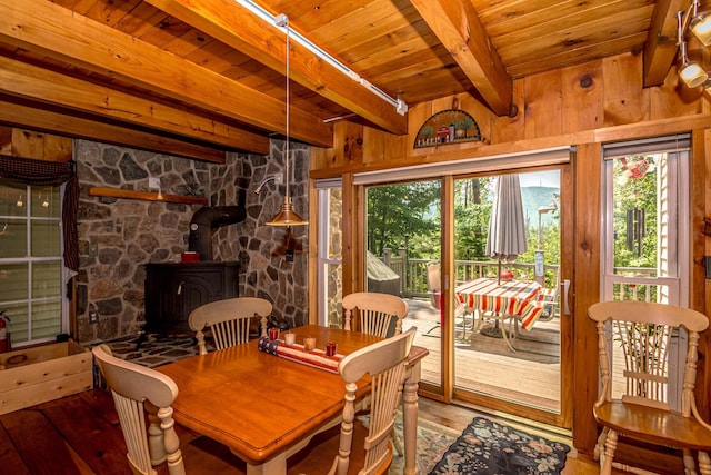 20 Pine Lane Rd, Ossipee, NH 03890 - dining room featuring hardwood / wood-style flooring, healthy amount of natural light, a wooden ceiling with exposed beams, a wood stove, and wood walls