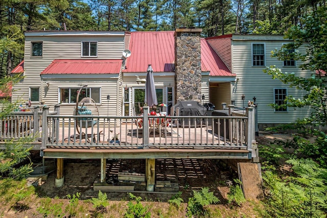 20 Pine Lane Rd, Ossipee, NH 03890 - rear view of house with a chimney, a deck, and a metal roof