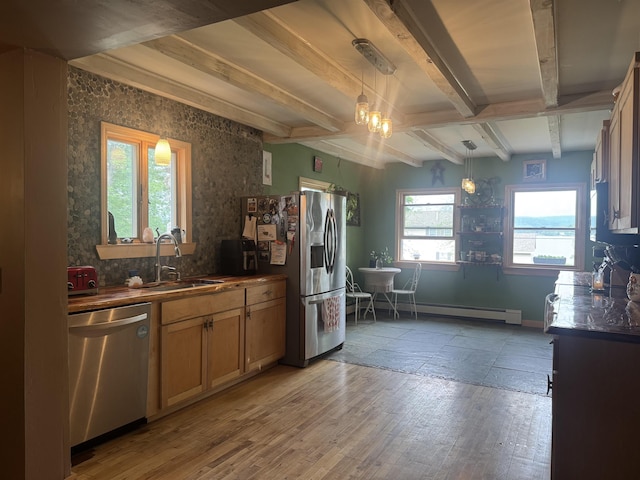 2940 Rte 30, Castleton, VT 05732 - kitchen featuring appliances with stainless steel finishes, beam ceiling, dark countertops, a baseboard heating unit, and light wood-style flooring