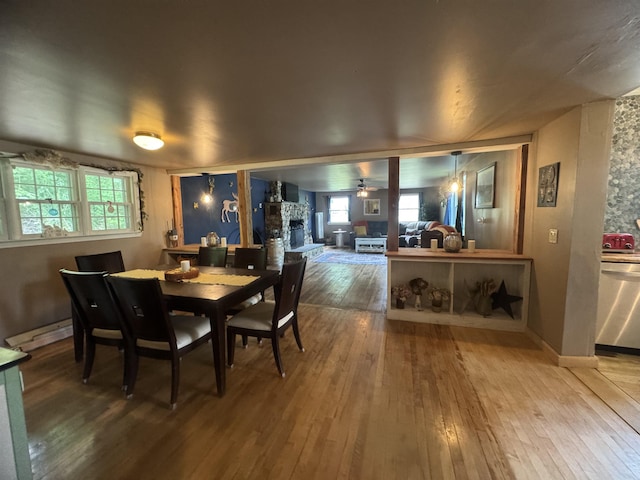 2940 Rte 30, Castleton, VT 05732 - dining space with hardwood / wood-style flooring, a ceiling fan, and a fireplace