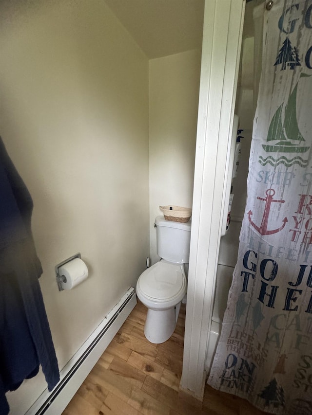 2940 Rte 30, Castleton, VT 05732 - full bath with a baseboard heating unit, wood finished floors, and curtained shower