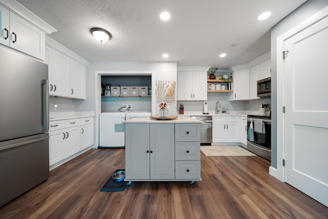 9 Swiftwater Dr Unit 5, Allenstown, NH 03275 - kitchen featuring stainless steel appliances, open shelves, independent washer and dryer, white cabinets, and a kitchen island