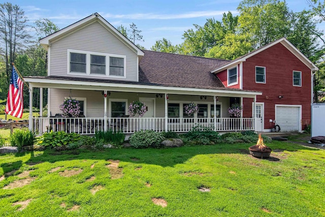 532 Randolph Rd, Stowe, VT 05672 - view of front of property with an outdoor fire pit, covered porch, a front yard, a garage, and a shingled roof