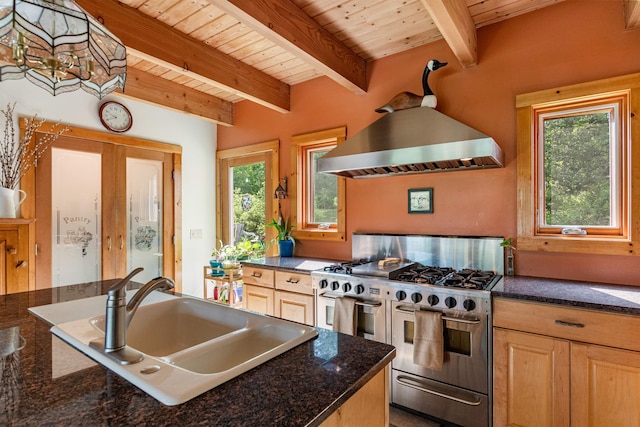 532 Randolph Rd, Stowe, VT 05672 - kitchen featuring range with two ovens, a wood ceiling with exposed beams, wall chimney exhaust hood, healthy amount of natural light, and light brown cabinetry